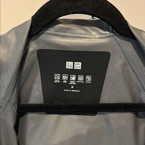 Woman’s black raincoat